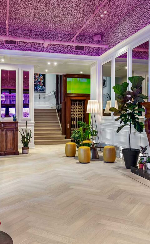 rendering of Gladstone House lobby with graphic painted ceiling and mid century modern furniture