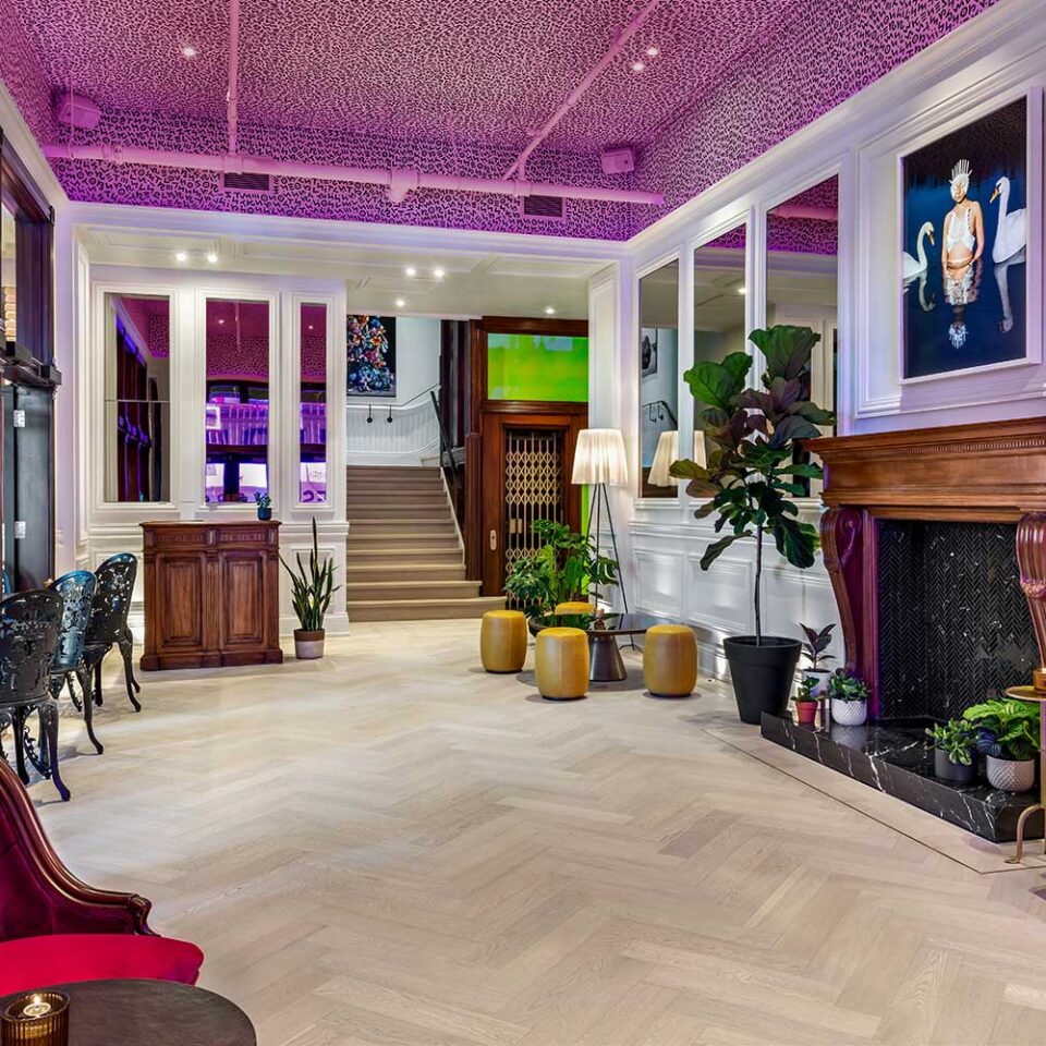 rendering of Gladstone House lobby with graphic painted ceiling and mid century modern furniture