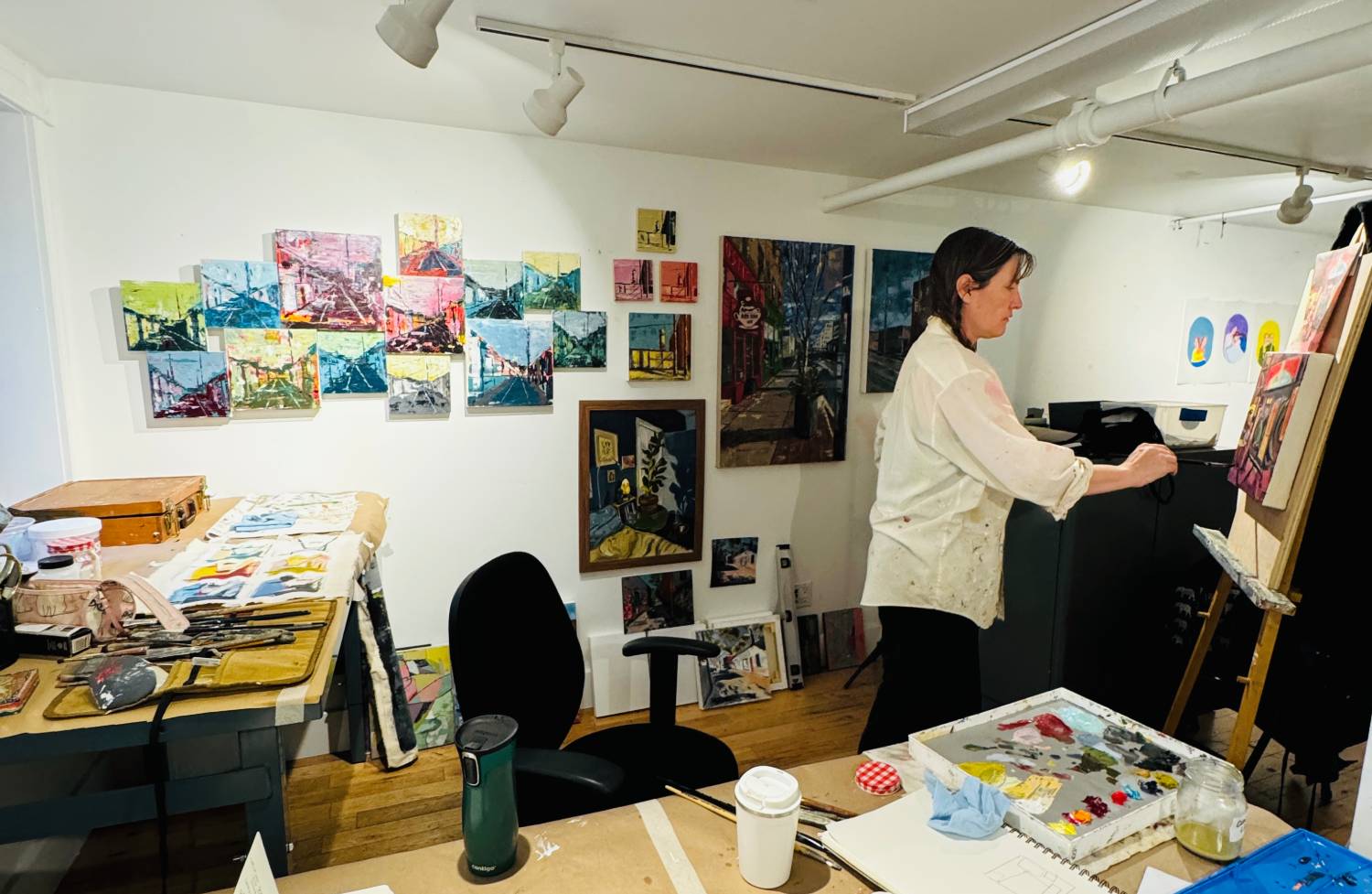 a woman painting in an art studio