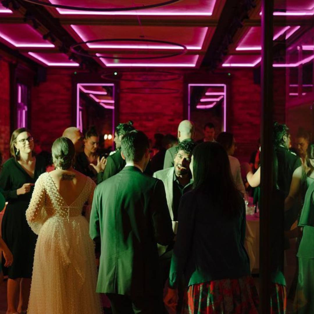 a group of people standing around in a room