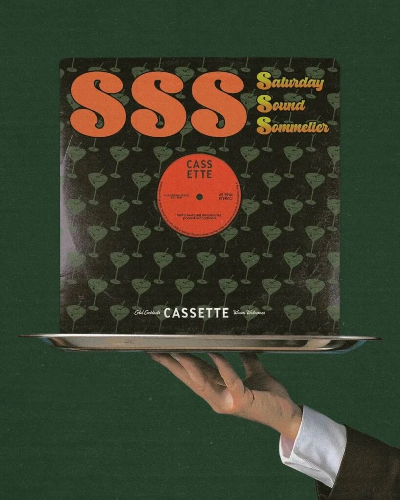 a person holding a tray with a vinyl album on it