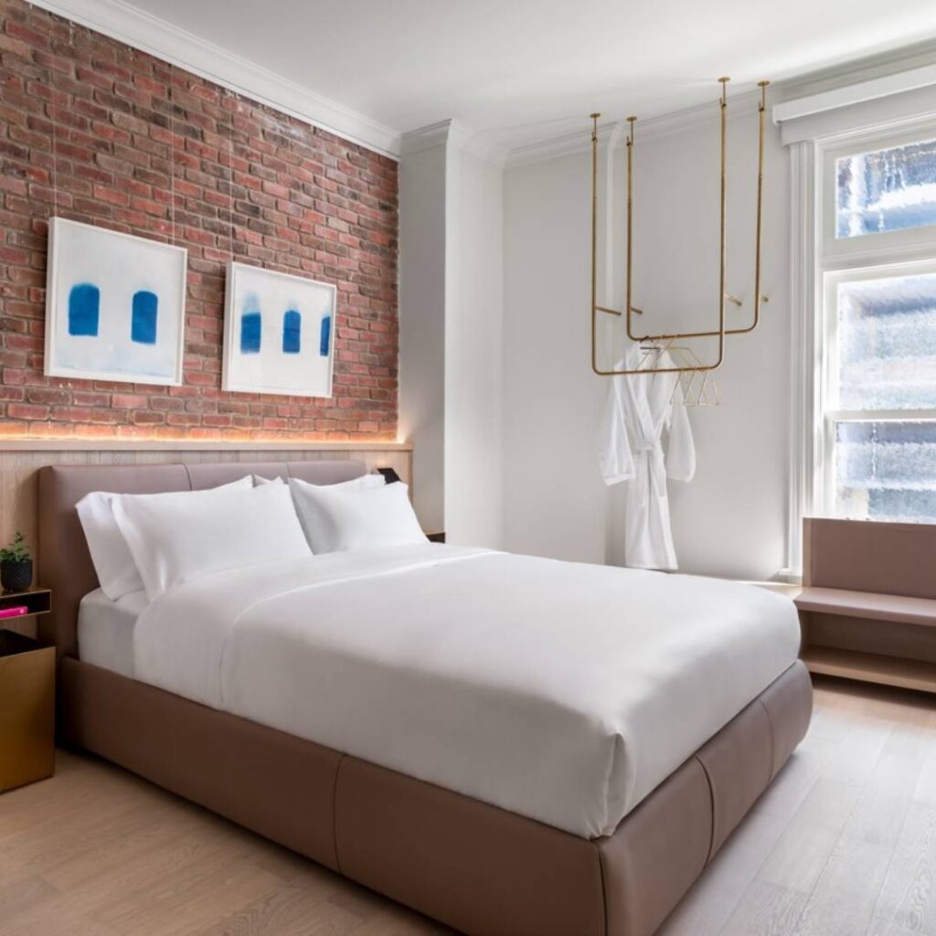  bedroom with a bed and a brick wall