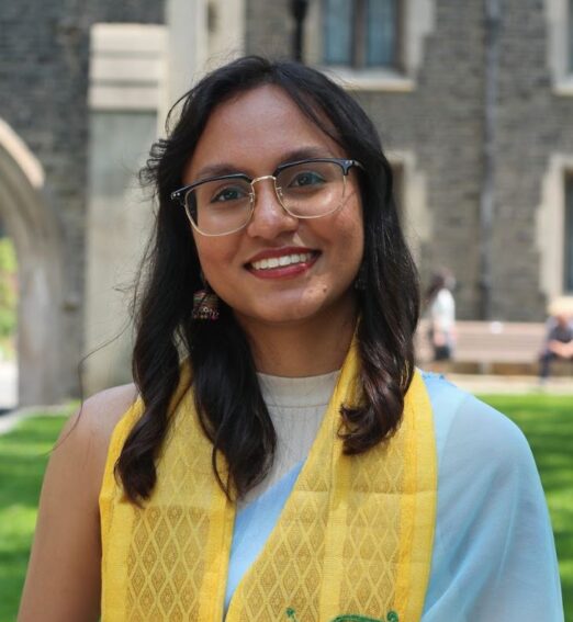a woman wearing glasses and a yellow scarf