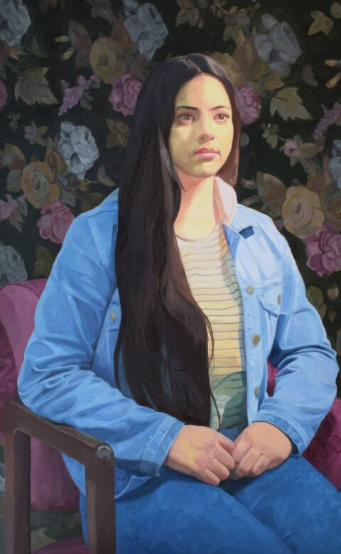 Painted portrait of a seated woman with long dark hair wearing a blue jacket against a dark floral background.